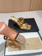 ALAIA TWO-STRAPS HIGH HEEL SANDALS IN GOLDEN PATENT LAMBSKIN