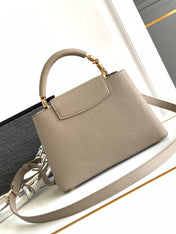 CAPUCINES BB 27 IN KHAKI BROWN TAURILLON GOLD HARDWARE