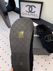 FLAT MULE IN BLACK SUEDE AND LAMB FUR LINING