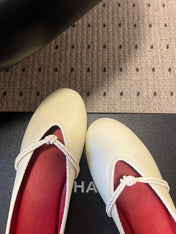 BOTTEGA VENETA 26S FLAT MULES IN CREAM WHITE LAMBSKIN
