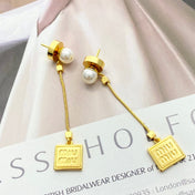 MIUMIU 26S PEARL BAR DROP LOGO EARRINGS IN GOLD TONE METAL 629846