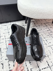 PRADA 26S SNEAKERS IN BLACK SHINY CALFSKIN