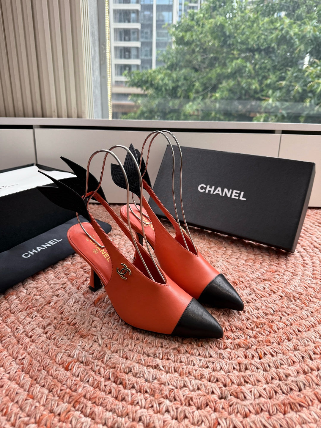 CHANEL 26S POINTED TOE HIGH HEEL SLINGBACKS IN ORANGE LAMBSKIN WITH BLACK FLORAL APPLIQUE