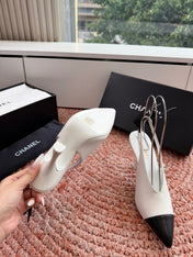 CHANEL 26S POINTED TOE HIGH HEEL SLINGBACKS IN WHITE LAMBSKIN WITH BLACK FLORAL APPLIQUE