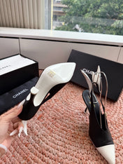 CHANEL 26S POINTED TOE HIGH HEEL SLINGBACKS IN BLACK AND WHITE LAMBSKIN WITH FLORAL APPLIQUE