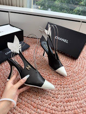 CHANEL 26S POINTED TOE HIGH HEEL SLINGBACKS IN BLACK AND WHITE LAMBSKIN WITH FLORAL APPLIQUE