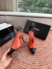 CHANEL 26S POINTED TOE HIGH HEEL SLINGBACKS IN ORANGE LAMBSKIN WITH BLACK FLORAL APPLIQUE