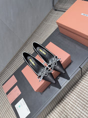 MIUMIU 26S POINTED TOE PUMPS 55MM IN BLACK AND WHITE CALFSKIN WITH BOW