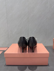 MIUMIU 26S POINTED TOE PUMPS 55MM IN BLACK AND WHITE CALFSKIN WITH BOW