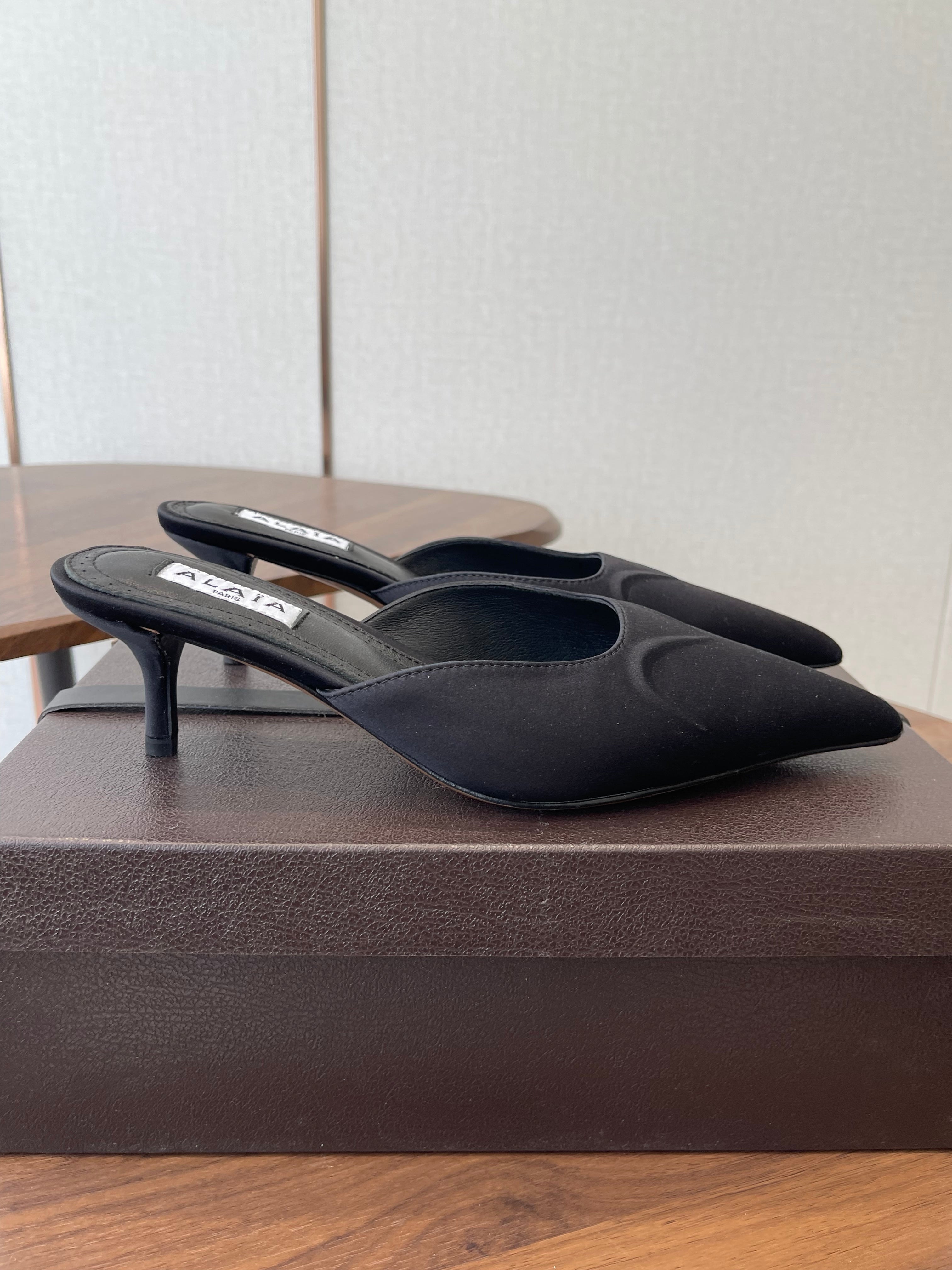ALAIA 26S HEELED MULES 50 MM IN BLACK FABRIC