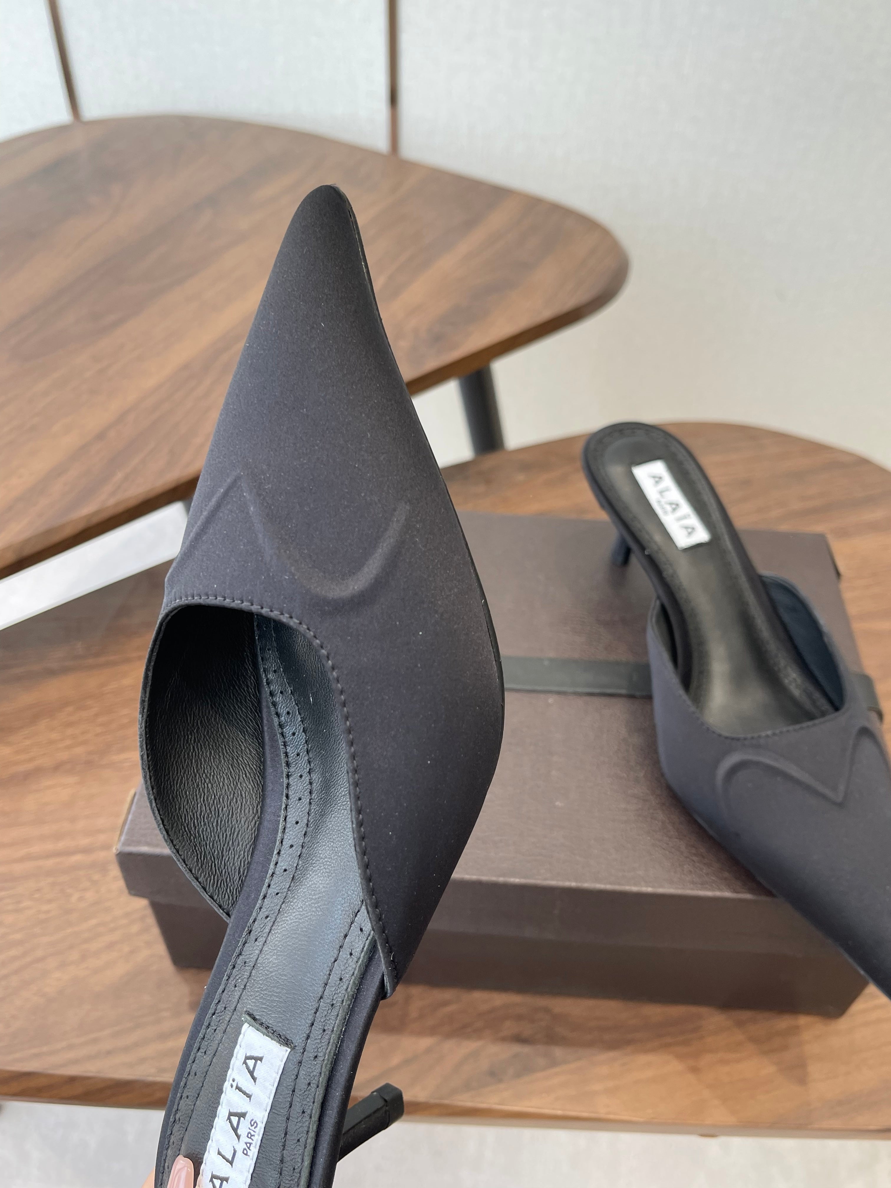 ALAIA 26S HEELED MULES 50 MM IN BLACK FABRIC