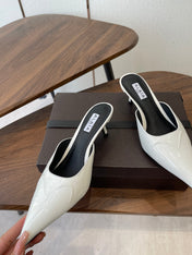 ALAIA 26S HEELED MULES 50 MM IN WHITE GLOSSY CALFSKIN