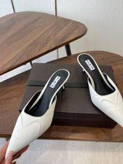 ALAIA 26S HEELED MULES 50 MM IN WHITE FABRIC