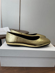 THE ROW 26S FLATS IN GOLD CALFSKIN