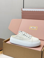 MIUMIU 26S SNEAKER MULES IN LIGHT YELLOW CANVAS