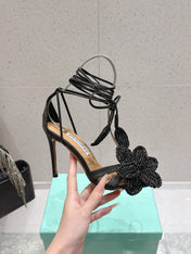 AQUAZZURA 26S FLORAL HEELS 100 MM IN BLACK WOVEN RAFFIA
