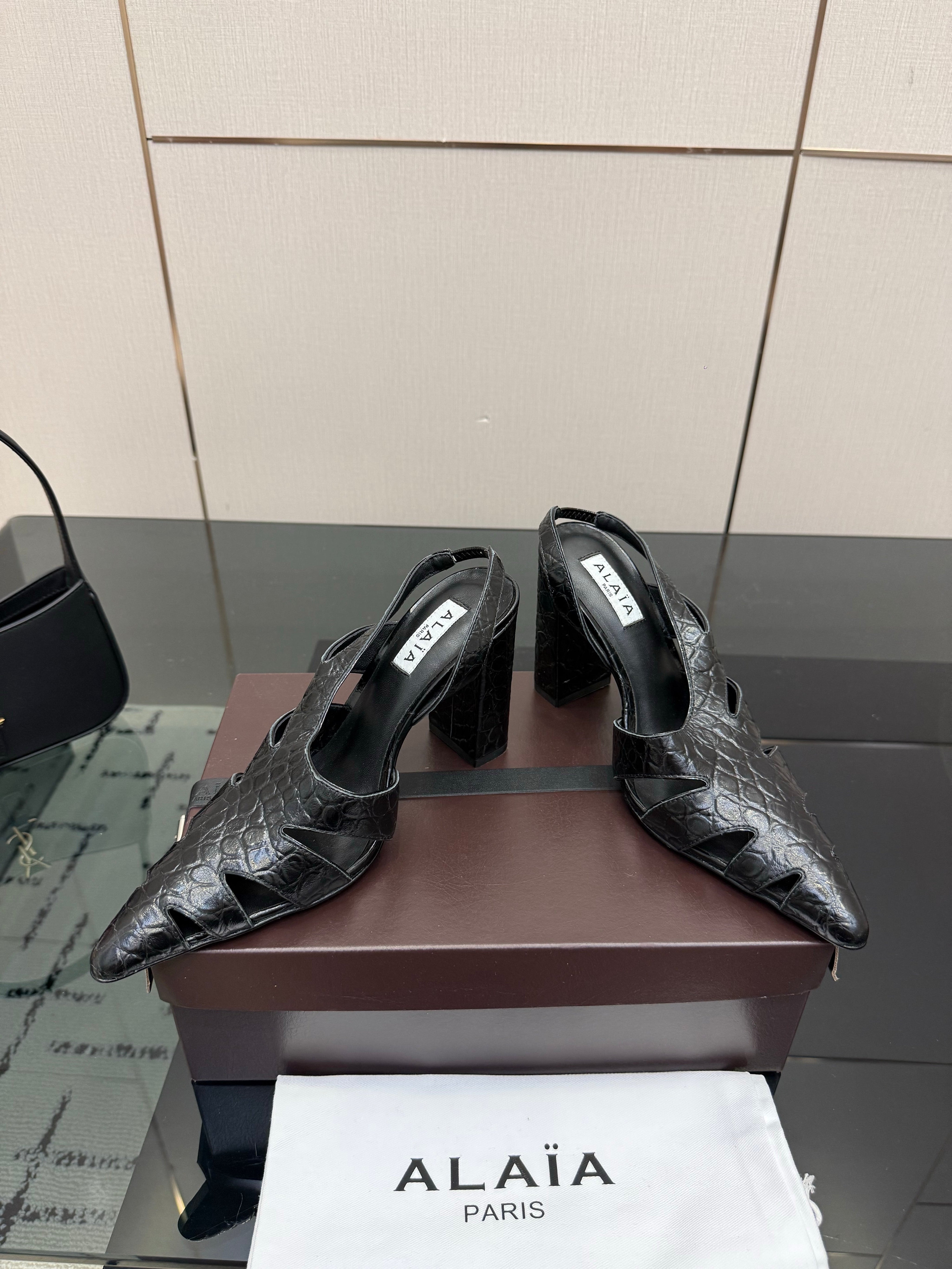 ALAIA 26S HEELED SLINGBACKS IN BLACK CROC-EMBOSSED LEATHER