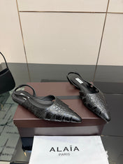 ALAIA 26S CUT-OUT SLINGBACK FLATS IN BLACK CROC-EMBOSSED LEATHER