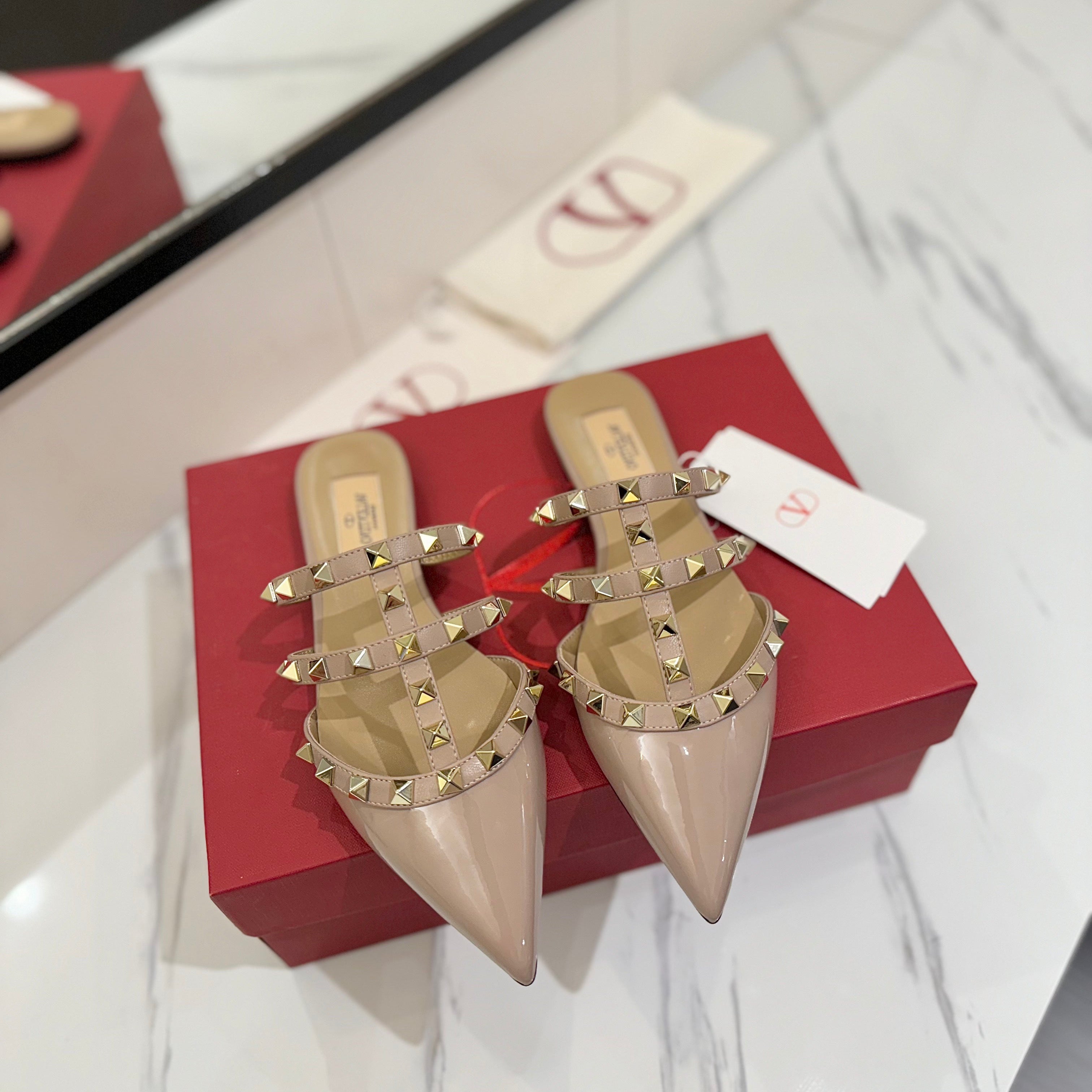 VALENTINO 26S STUDDED FLAT MULES IN NUDE PATENT CALFSKIN
