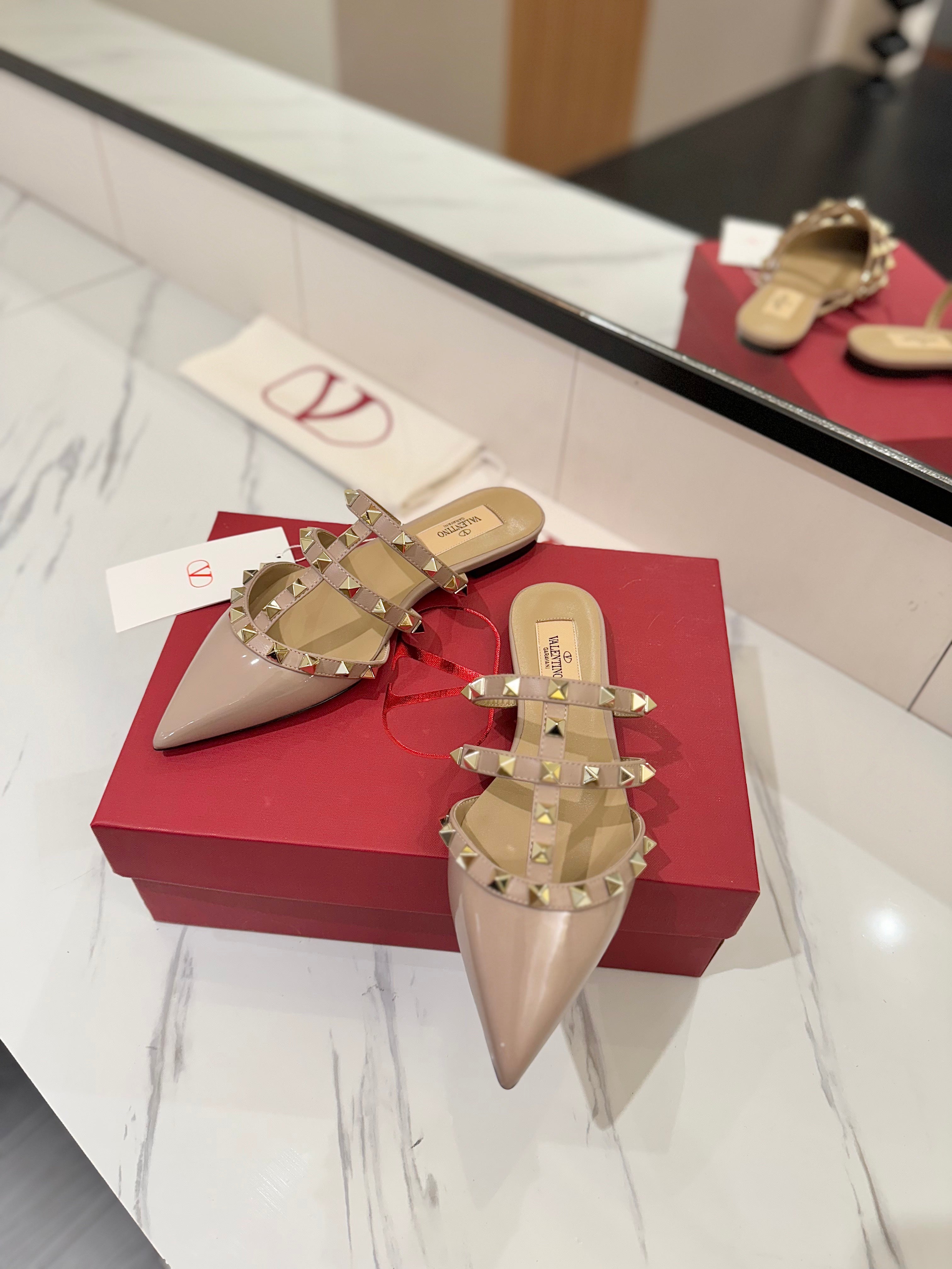 VALENTINO 26S STUDDED FLAT MULES IN NUDE PATENT CALFSKIN