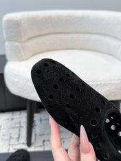 ALAIA 26S FLAT SLIP-ONS IN BLACK SUEDE WITH OPENWORK PATTERN