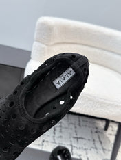 ALAIA 26S FLAT SLIP-ONS IN BLACK SUEDE WITH OPENWORK PATTERN