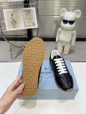 PRADA 26S LACE UP SNEAKERS IN BLACK CALFSKIN