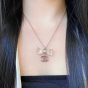 CHANEL 26S DOUBLE C LOGO CLEAR BOW PENDANT NECKLACE IN GOLD METAL 629174