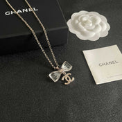 CHANEL 26S DOUBLE C LOGO CLEAR BOW PENDANT NECKLACE IN GOLD METAL 629174