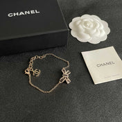 CHANEL 26S CRYSTAL BOW CHAIN BRACELET IN GOLD METAL 629980