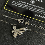 CHANEL 26S DOUBLE C LOGO CRYSTAL BOW & STAR PENDANT NECKLACE IN SILVER METAL 631019