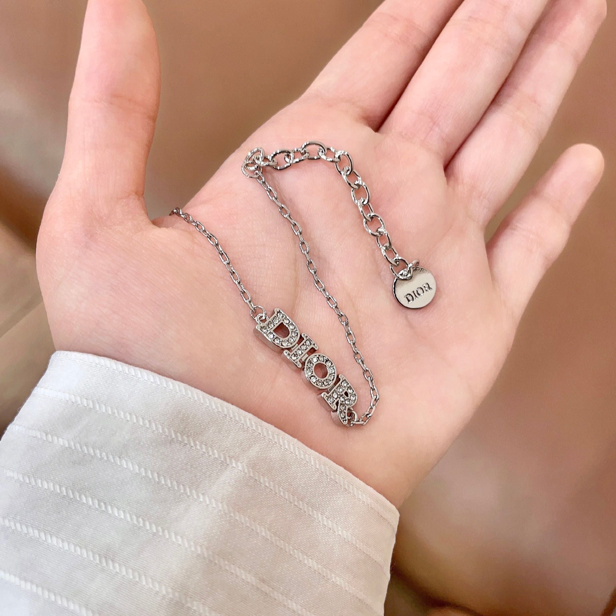 CD 26S PAVE LOGO LETTER BRACELET IN SILVER TONE METAL 631807