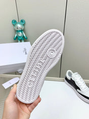 SNEAKER WITH TRIOMPHE IN BLACK AND WHITE CALFSKIN