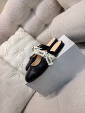 DIOR 26S FLAT MULES IN BLACK CALFSKIN WITH J'ADIOR BOW