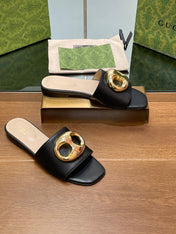 FLAT MULE IN BLACK CALFSKIN WITH GOLD HARDWARE