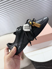 MIUMIU 26S GYMNASIUM SNEAKER IN BLACK CALFSKIN WITH GOLD BUCKLED STRAP