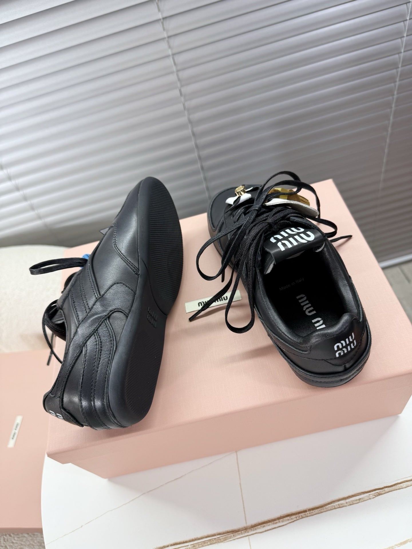 MIUMIU 26S GYMNASIUM SNEAKER IN BLACK CALFSKIN WITH GOLD BUCKLED STRAP