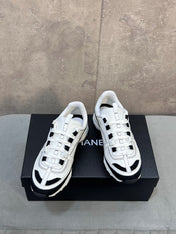 CHANEL 26S RUNNER CC LOGO SNEAKERS IN WHITE AND BLACK CALFSKIN