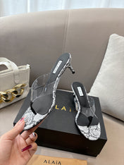 ALAIA HEELED THONG 25S 55 MM IN WHITE AND BLACK LAMBSKIN SNAKE-EMBOSSED WITH CLEAR STRAP