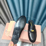 MULES SLIPPERS BLACK COWHIDE WITH GOLD COIN