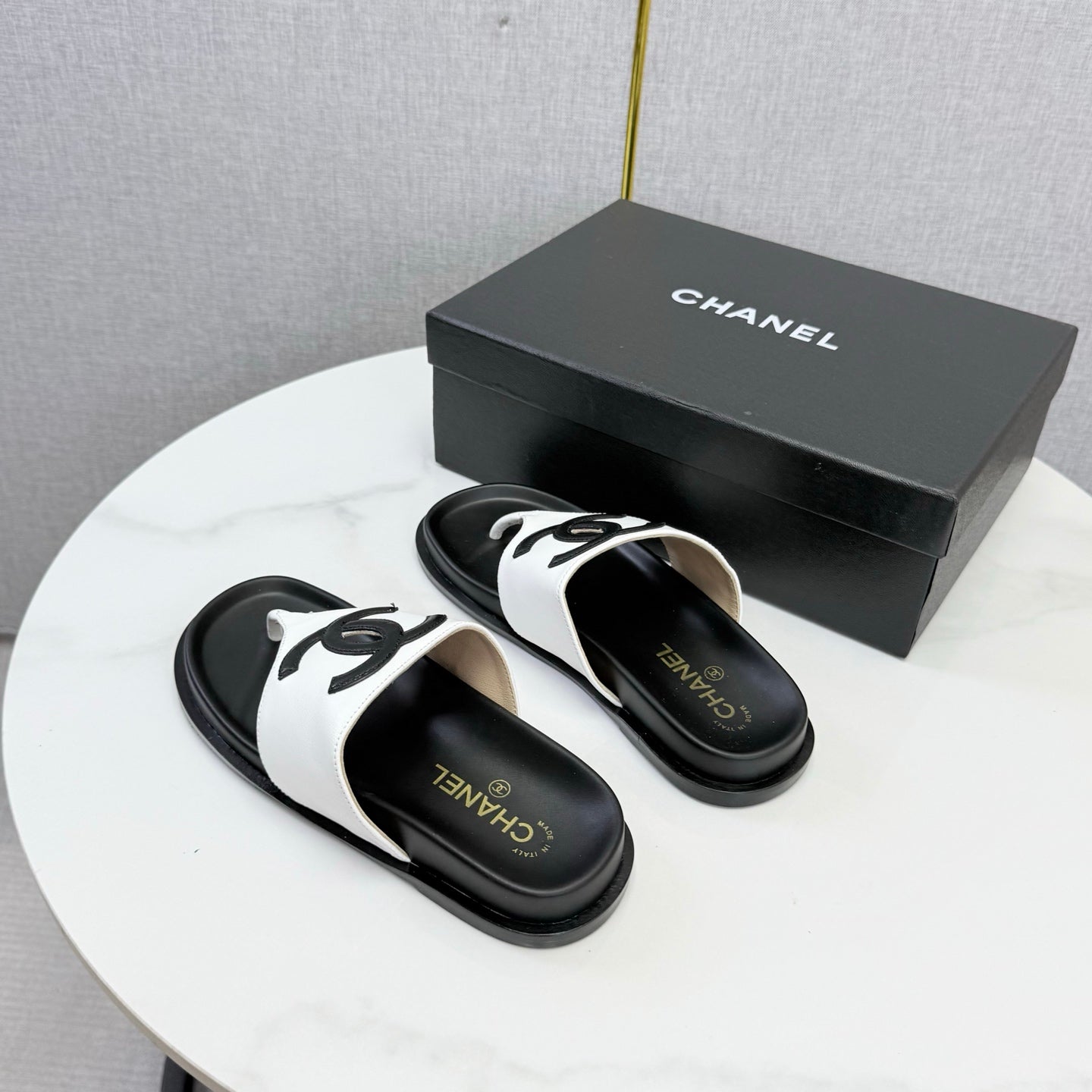 CHANEL 26S CC THONG SLIDES IN WHITE AND BLACK LAMBSKIN