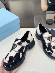 PRADA 26S LOAFERS IN WHITE AND BLACK COW PRINT PONY HAIR
