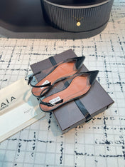 ALAIA FLAT SLINGBACK IN BLACK PATENT CALFSKIN AND FILM