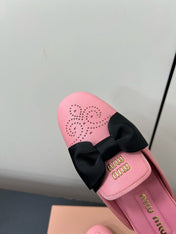 BOW MULES IN PINK SHEEPSKIN