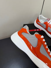 PRADA 26S SNEAKERS IN RED ORANGE PATENT CALFSKIN AND WHITE MESH