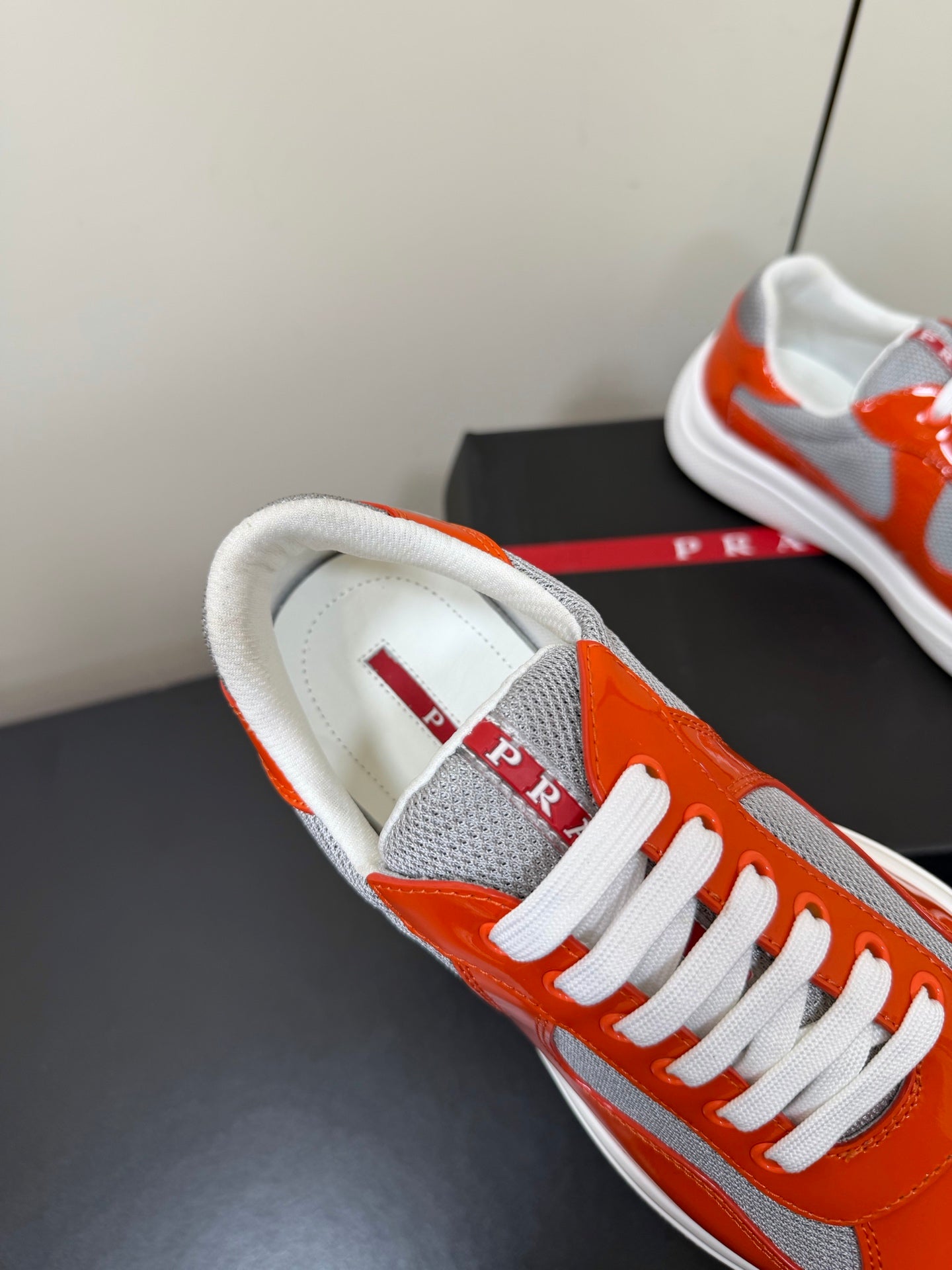PRADA 26S SNEAKERS IN RED ORANGE PATENT CALFSKIN AND WHITE MESH