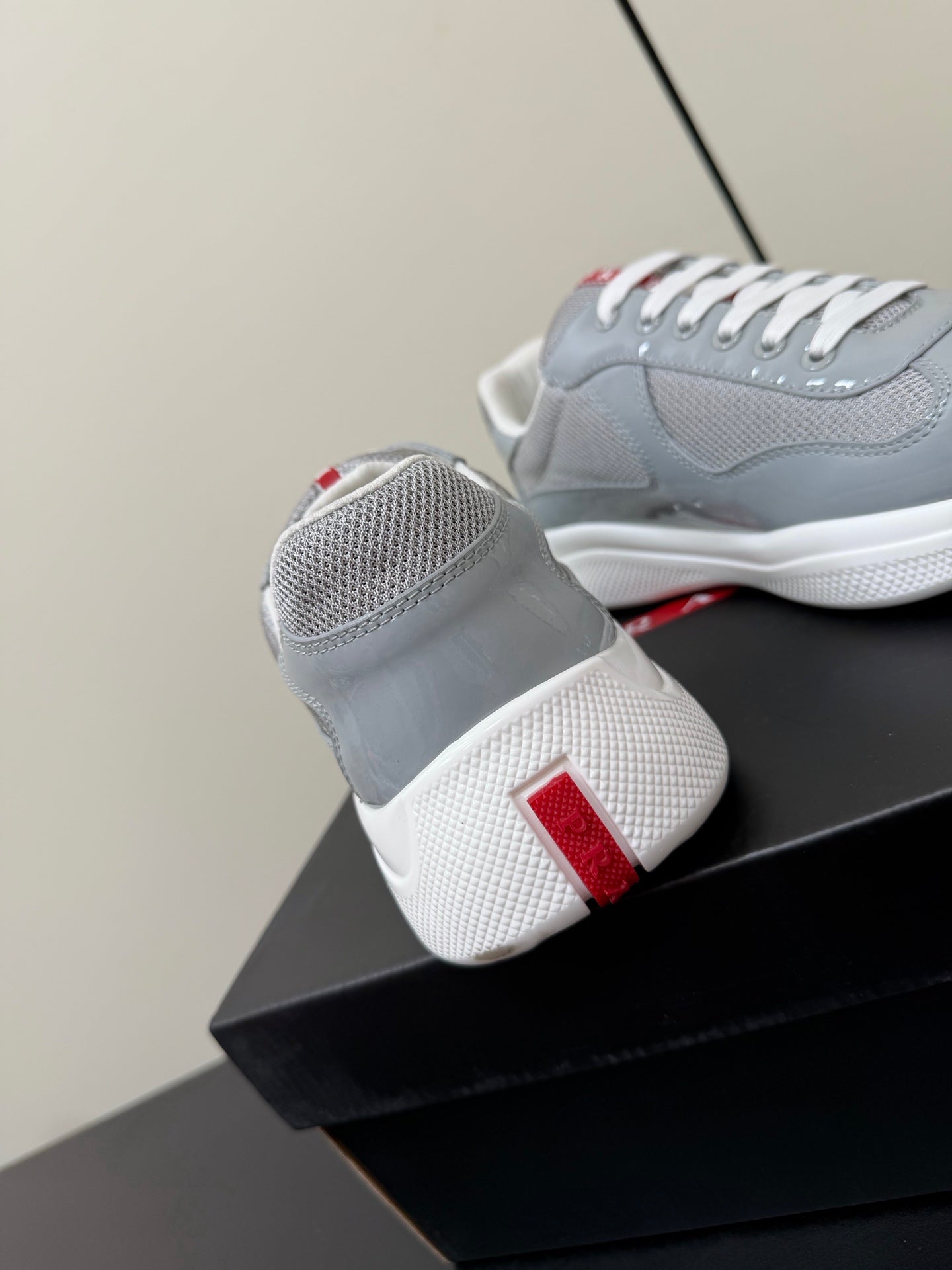 PRADA 26S SNEAKERS IN LIGHT GRAY PATENT CALFSKIN AND WHITE MESH