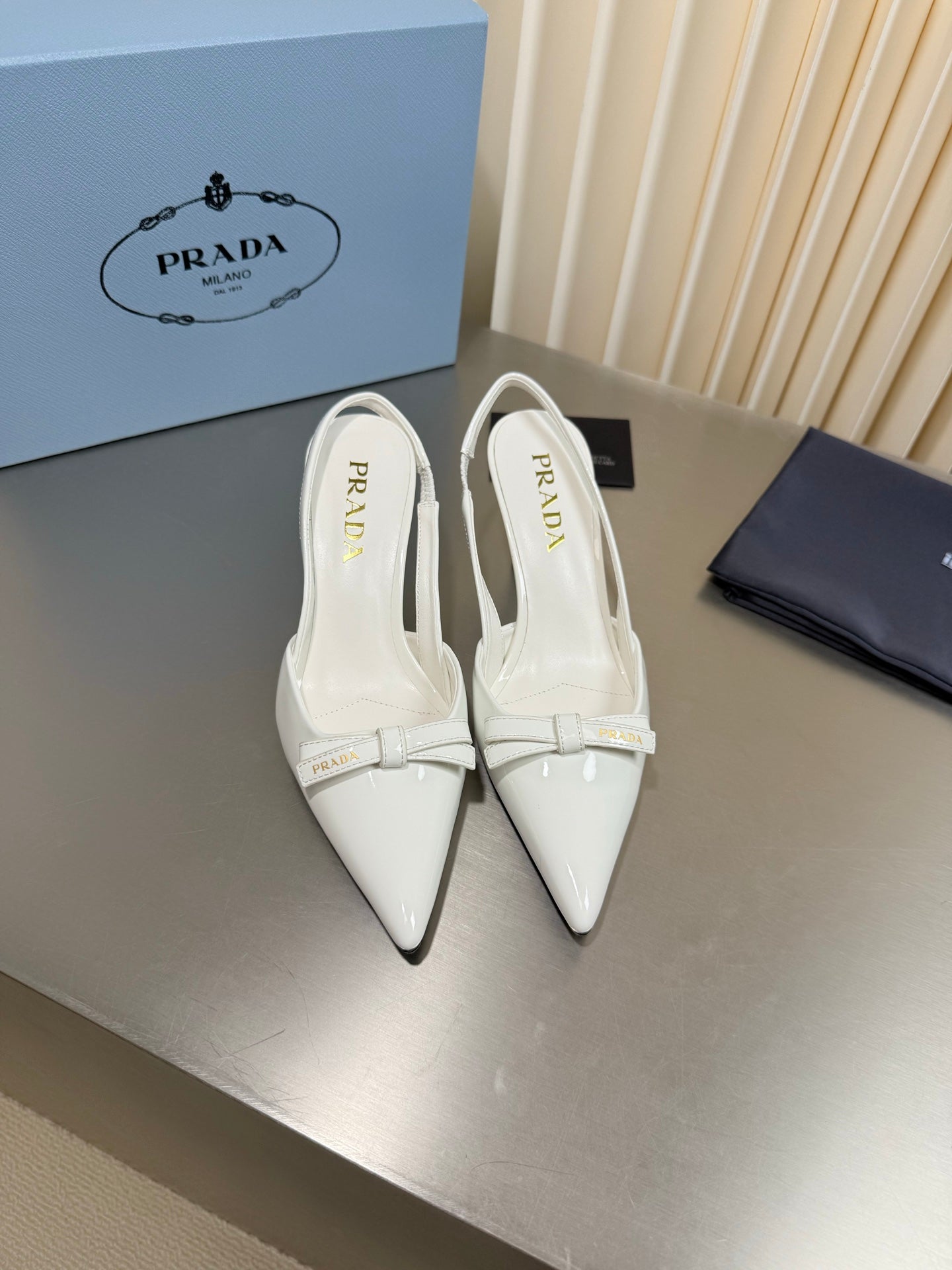 PRADA 26S POINTED-TOE SLINGBACK PUMPS IN WHITE PATENT CALFSKIN WITH BOW
