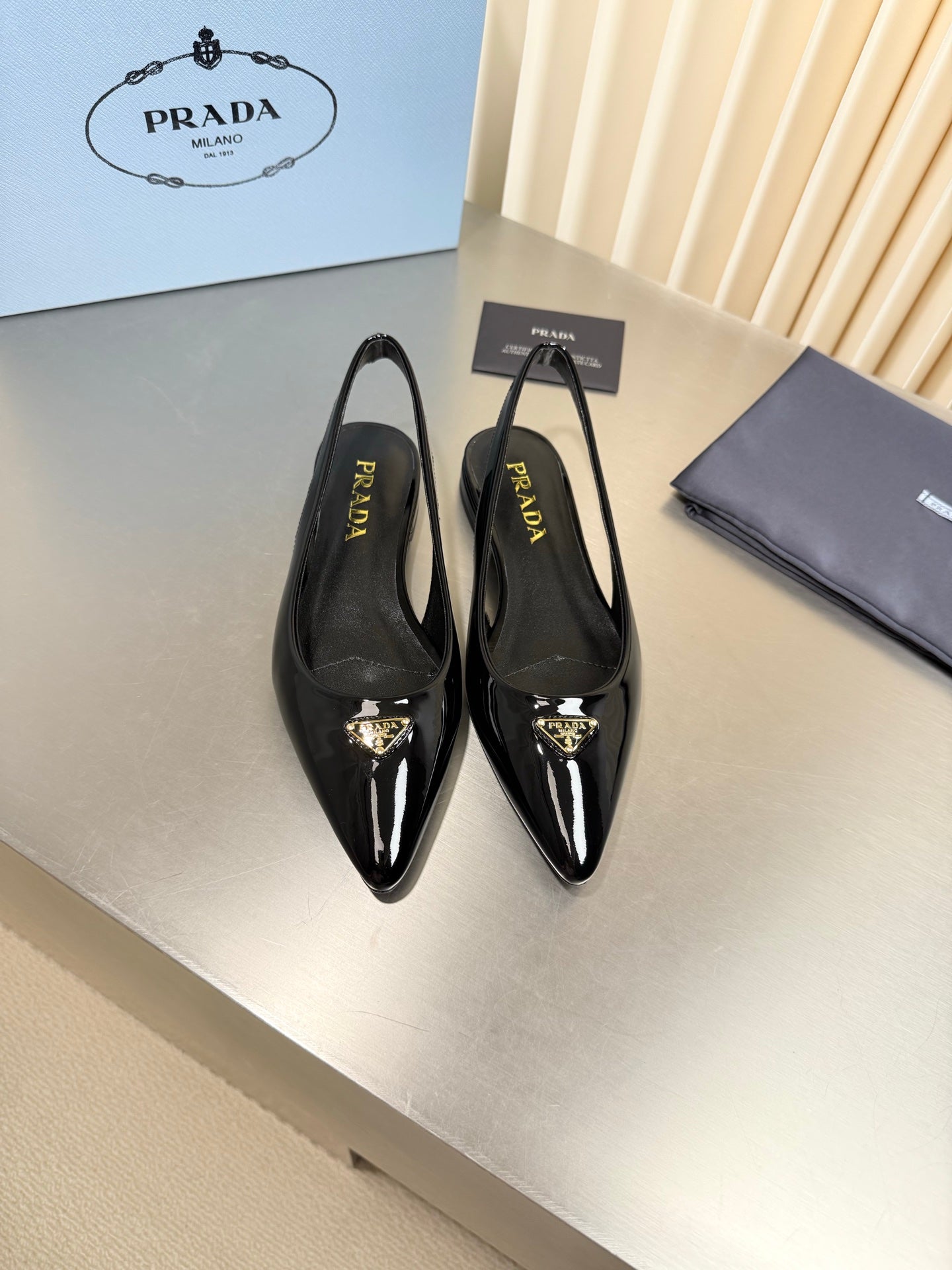 PRADA 26S SLINGBACK FLATS IN BLACK PATENT CALFSKIN WITH GOLD HARDWARE