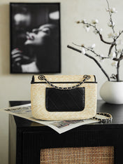 CHANEL 26S CLASSIC FLAP MEDIUM 23 IN NATURAL RAFFIA AND BLACK CALFSKIN GOLD HARDWARE